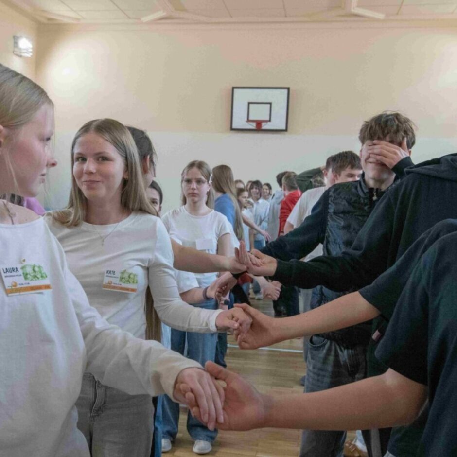 skolēni dejo dejas tērpušies baltos t-kreklos